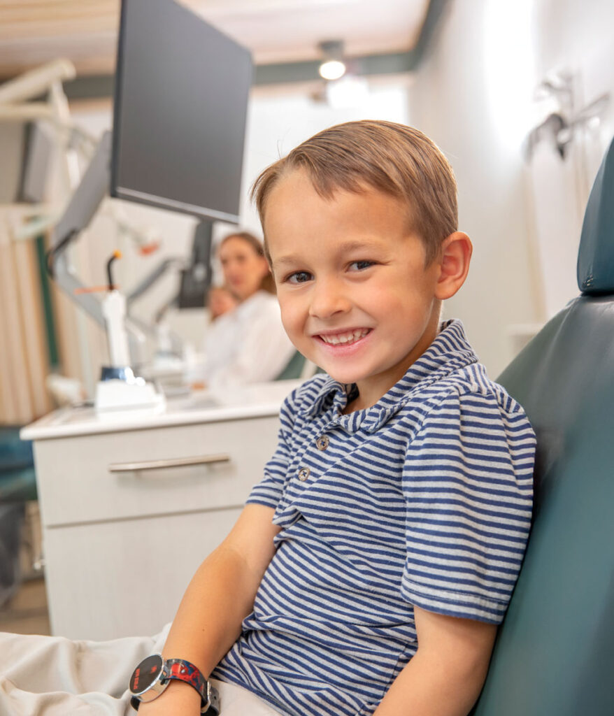 A kid smiling because of the Clubhouse orthodontist